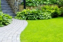 Manicured lawn with stone block paved area