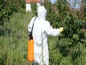 Man in protective body suit spraying pesticides